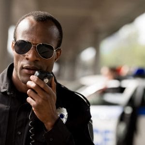 police officer talking by walkie-talkie radio set