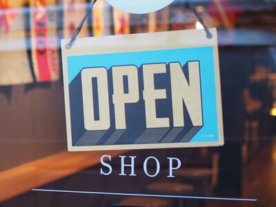 Image of an open sign at a store | RPA Lifestyle Creep Article