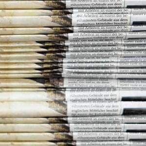 Stack of two sets of newspapers | COVID-19 News Coverage
