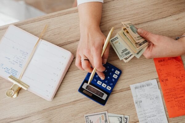 A person calculating bills | Spot Early Financial Trouble with RPA's Credit Warning Signs Checklist