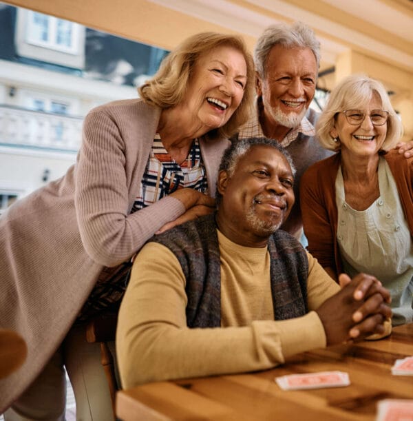 Group of elderly people are meeting to discuss retirement and are taking a selfie. Elders are speaking about the SECURE Act 2.0.