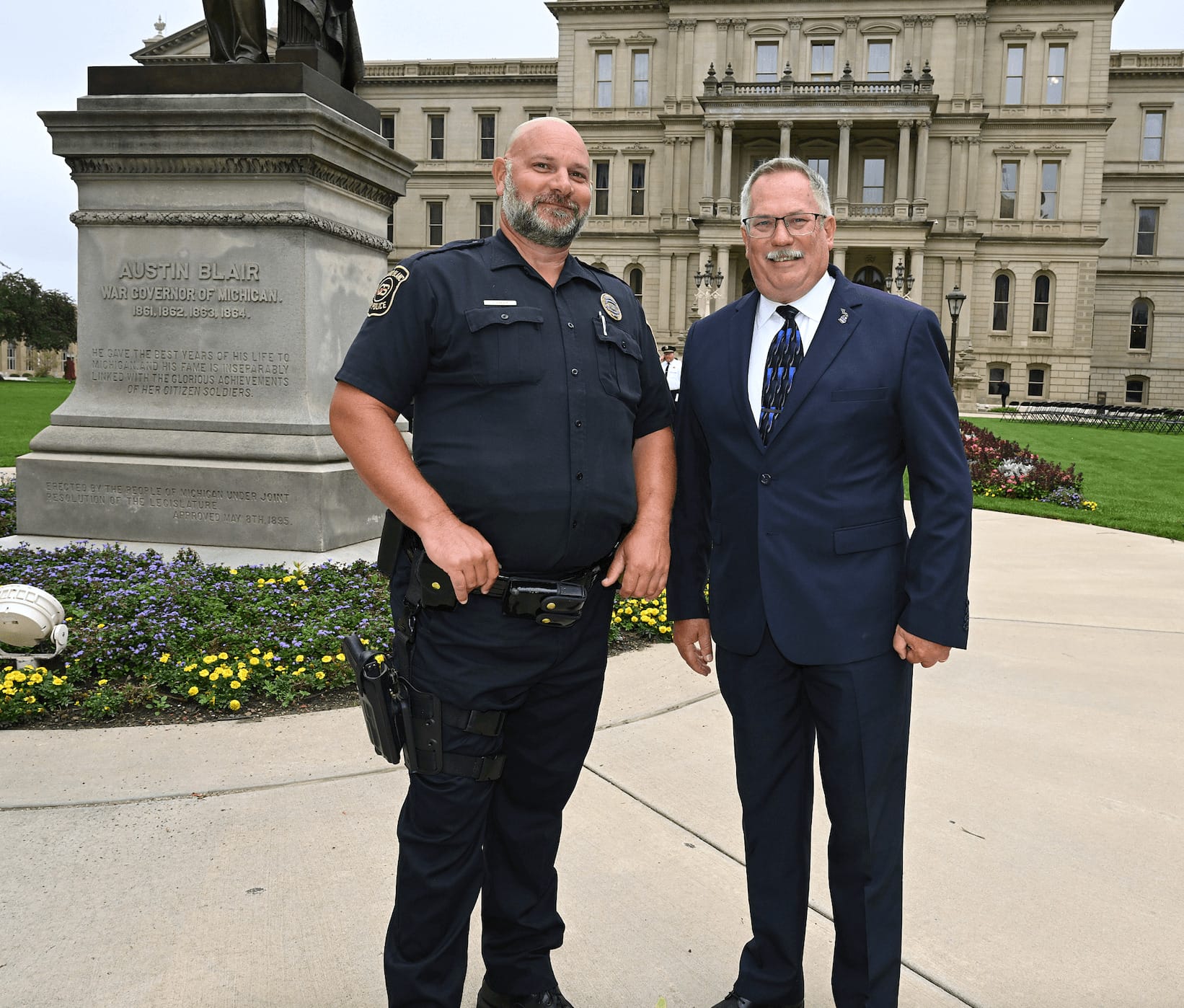 John Graver and Rep. Martin posing outside of the MI state capitol building after the 9/11 Memorial Celebration