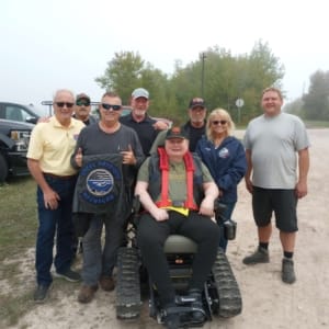 Group of POAM, Defender Mobility, and the family & friends of veteran Chris Giles who received a TracFab chair donation.