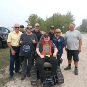 Group of POAM, Defender Mobility, and the family &amp; friends of veteran Chris Giles who received a TracFab chair donation.