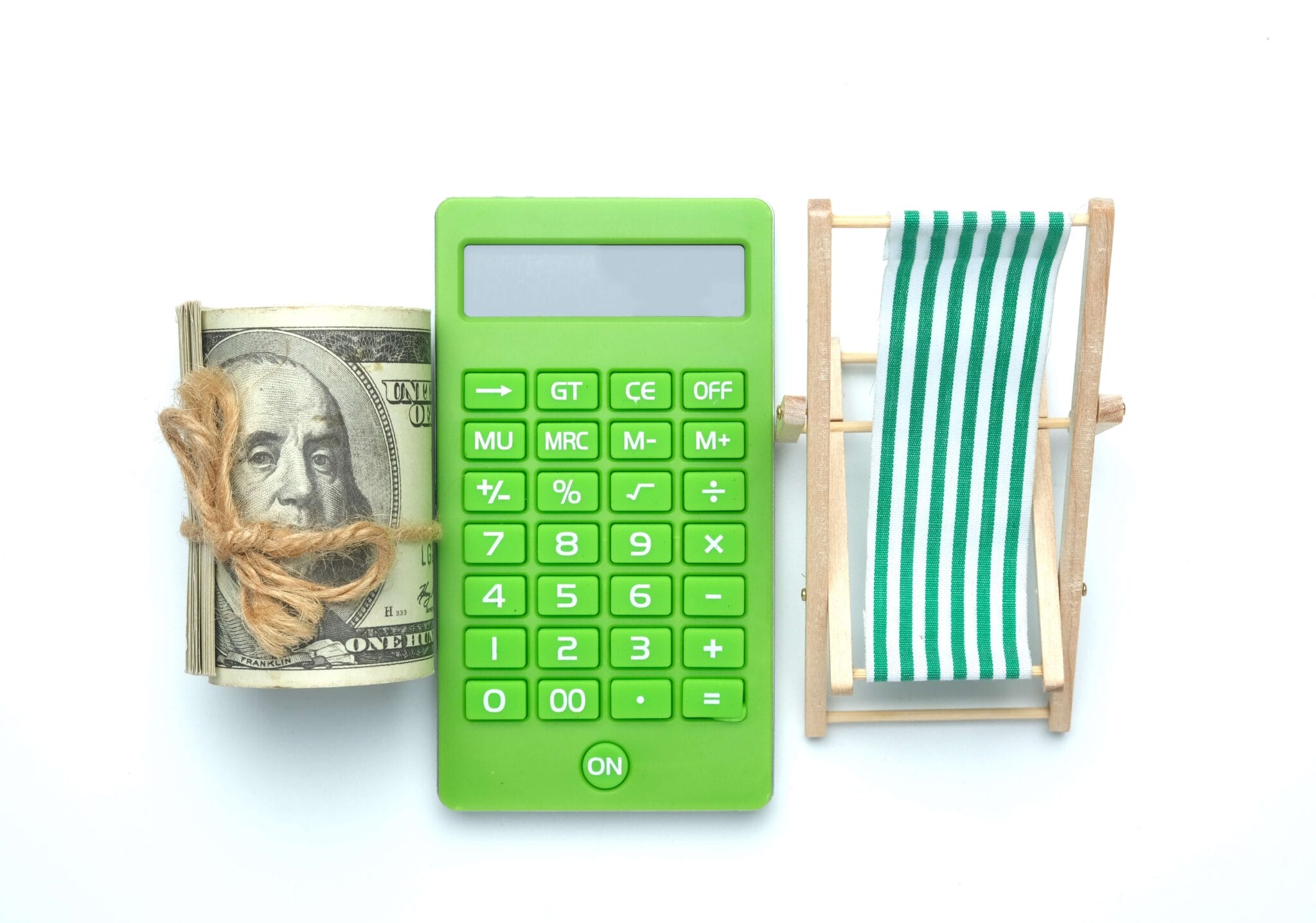 A flatlay picture of folding beach chair , retirement on calculator and roll of fake money on white background. Retirement plan and vacation concept. | 59.5 for retirement