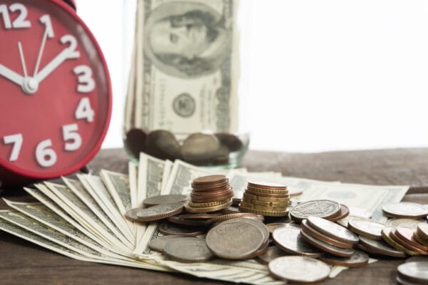 Close up of dollars and coins for currency exchange on white background