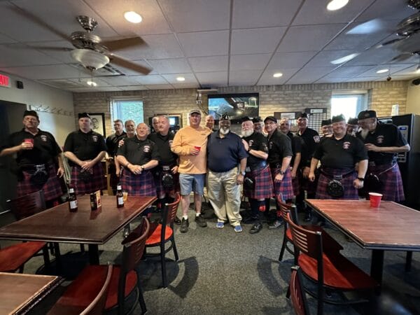 Executive Board member and Business Agent Gregg Allgeier is pictured with members of the Metro Detroit Police and Fire Pipes and Drums and First Vice Commander Dwyane McQueen of the American Legion's Kenneth H. Nash D.C. of Post #8. | National Police Week 2024