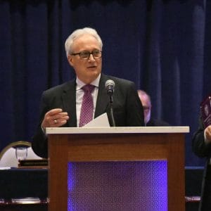 POAM Spring Update-POAM President Jim Tignanelli stands at a podium addressing members