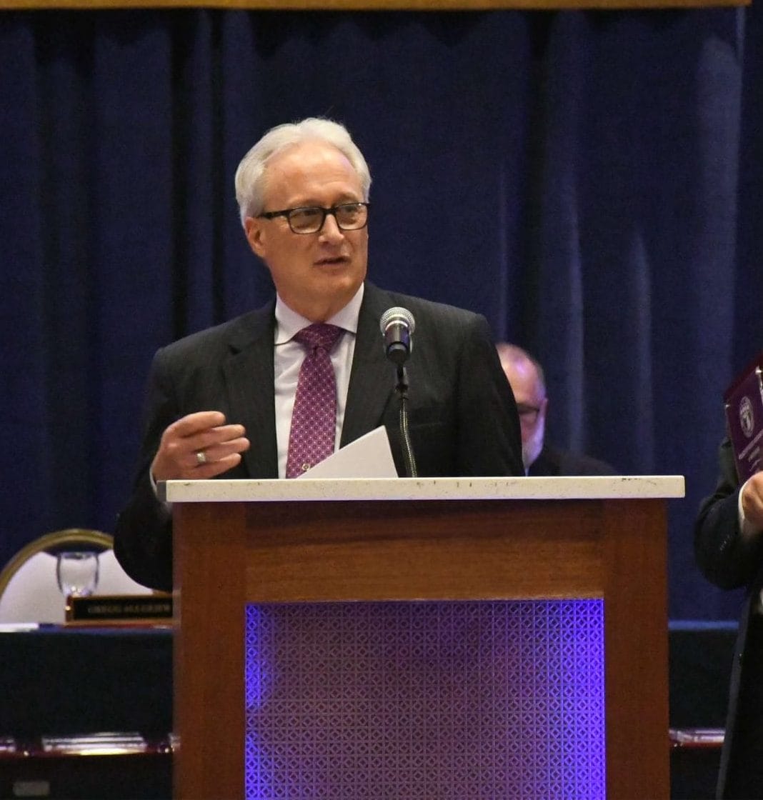 POAM Spring Update-POAM President Jim Tignanelli stands at a podium addressing members