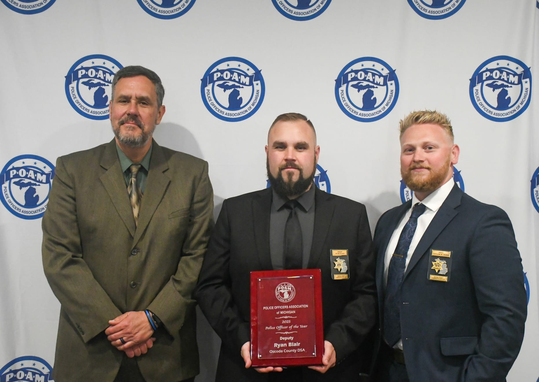 Oscoda County Deputy Ryan Blair receiving the 2025 POAM Police Officer of the Year Award.