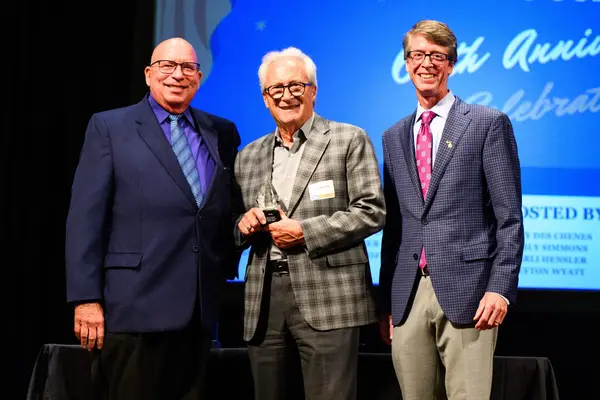 Kenneth E. Grabowski, Jim Tignanelli, and Brendan Ringlever on Stage with 40-Years of Legislative Achievements Award
