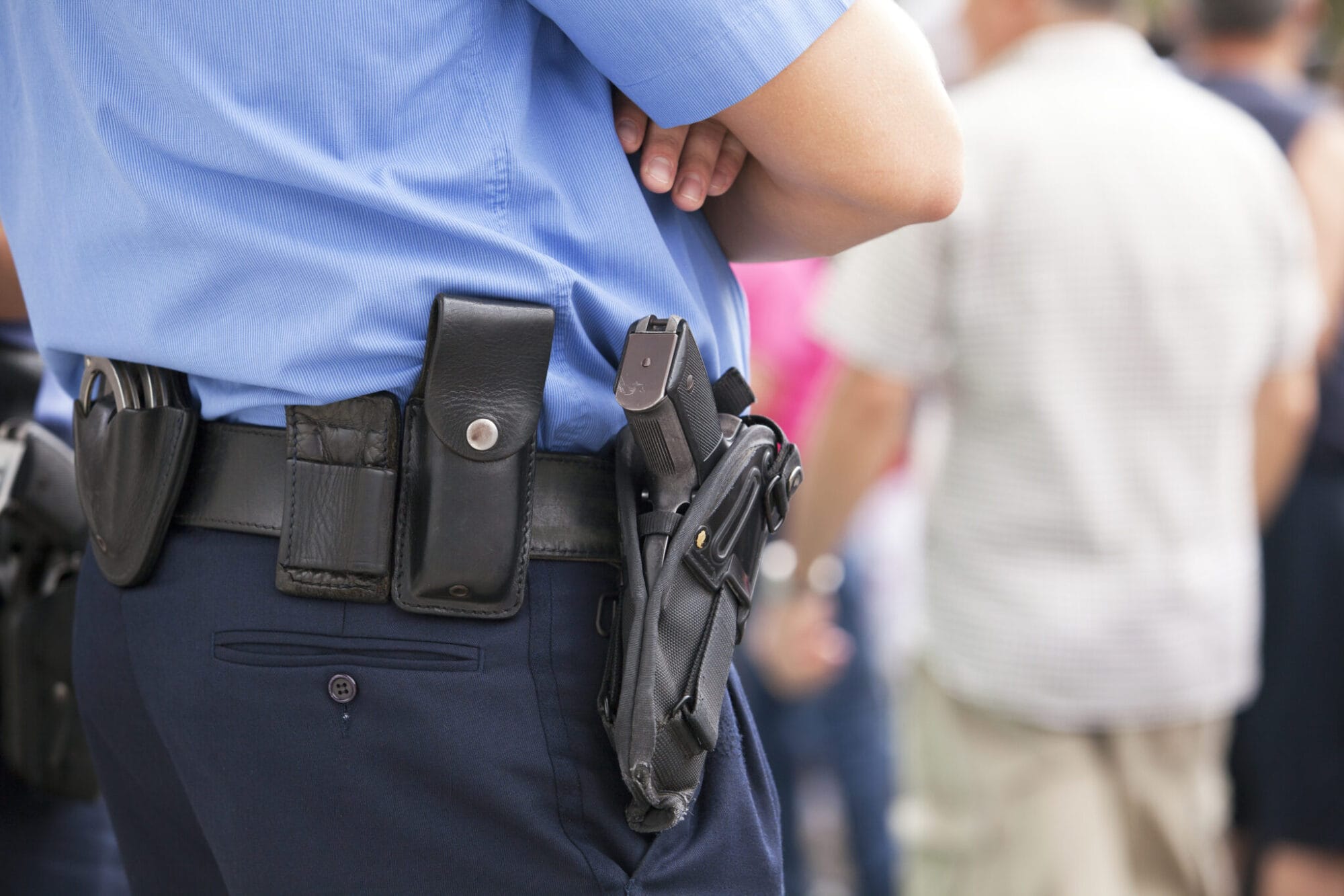 Harsher Penalties for disarming LEOs - Police Officer with gun holster